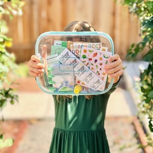 May include: A clear rectangular zippered pouch containing stationery items including a small address book, sticker sheets with alphabet letters and vegetable illustrations, and several cards with the text Happy Mail Has Arrived printed on them.