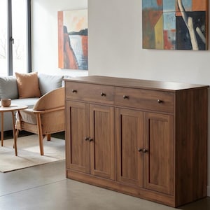 May include: A rectangular wooden sideboard featuring a dark brown wood grain finish, two horizontal drawers at the top with small round knobs, and four lower cabinet doors, each equipped with a matching round knob for opening and closing.