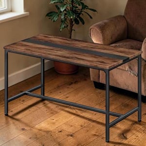 May include: A rectangular coffee table with a dark brown wood top and a black metal frame. The tabletop has a dark gray stripe down the center. The table is approximately 48 inches long, 24 inches wide, and 18 inches high.