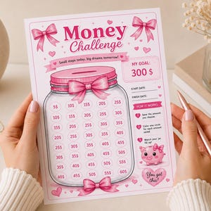 May include: A printed Money Challenge tracker sheet featuring a pink theme with bows, hearts, and a central jar illustration. The text reads Money Challenge, Small steps today, big dreams tomorrow!, My Goal: 300 $, Start Date, Finish Date, How it works, and You got this!.