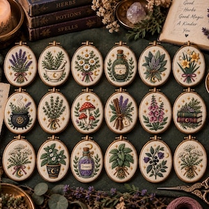 May include: A collection of eighteen oval embroidery hoops featuring detailed botanical and mystical designs on cream fabric. Each hoop displays unique motifs including lavender, mushrooms, potion bottles, herbs, and flowers, all framed in wood.
