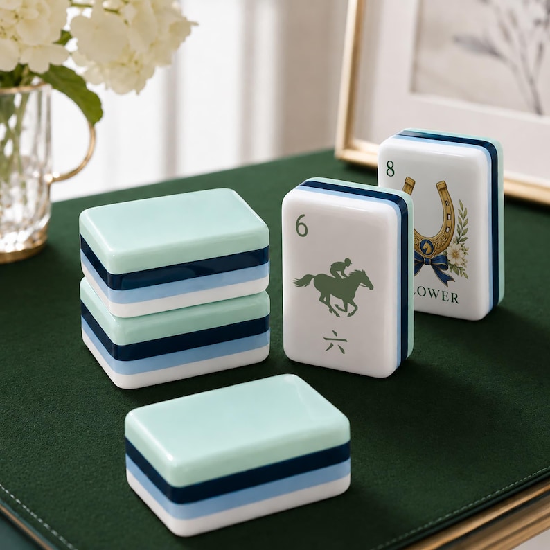 May include: A set of rectangular mahjong tiles featuring a layered color scheme of mint green, navy blue, and light blue. One tile displays a jockey on a horse with the number 6 and a Chinese character, while another shows a horseshoe and the number 8.