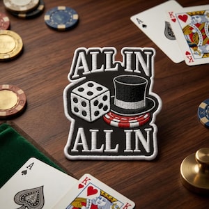 May include: A black and white patch with the words "ALL IN" above and below a die, top hat, and poker chip design. Playing cards and poker chips are scattered around the patch on a wooden surface.