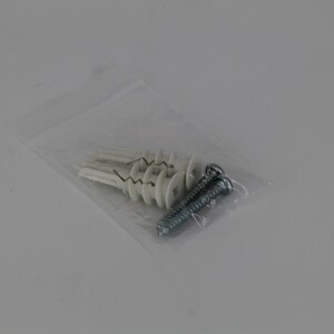 May include: A clear plastic bag containing several white wall anchors and two silver screws. The anchors have a unique design with a central opening and a ribbed exterior. The screws are metal with a spiral design.