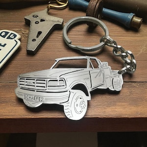 May include: A set of three ceramic mugs with a speckled, matte finish. The mugs are in shades of cream, light gray, and dark gray. Each mug has a simple, minimalist design, perfect for coffee or tea.