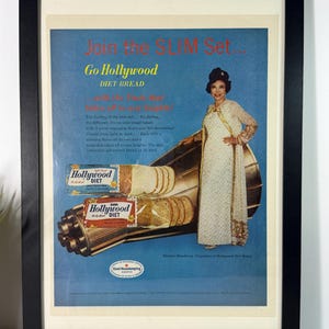 May include: Framed vintage advertisement for Hollywood Diet Bread. The ad features a woman in a white dress, a loaf of bread, and the text "Join the Slim Set... Go Hollywood Diet Bread."