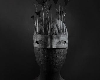 Avant-garde leather mask with feathers