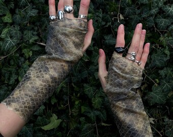 Avant-garde silicone mittens designed to look like scaly leather.