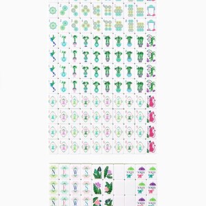 May include: A complete set of white Mahjong tiles with various colorful illustrations. The tiles feature symbols, numbers, and images of flowers, plants, and animals. The set includes tiles with the letters N, E, W, and S, and the word "Joker".