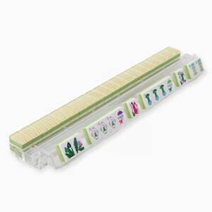 May include: A set of Mahjong tiles, featuring a light wood-colored tile rack and individual tiles with green and white designs. The tiles display various symbols and characters, suggesting a traditional game.