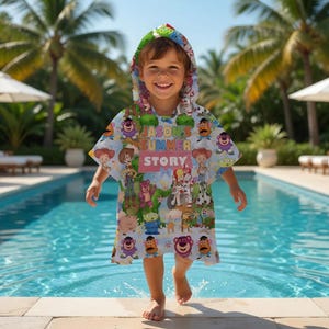 May include: A light blue hooded beach towel featuring various cartoon characters. The towel has the text "JASON'S SUMMER STORY" printed on it. The child is standing near a swimming pool.