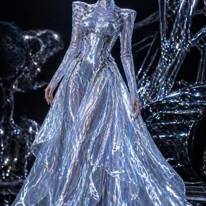 green emerald velvet dress A futuristic dress with layers of laser-cut silver mirror