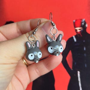 May include: A white ceramic mug with a black handle and the text "But First, Coffee" in a handwritten style. The mug is on a white surface. The mug is 4 inches tall.