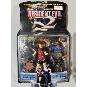 Könnte beinhalten: Ein Resident Evil 2 Actionfiguren-Set mit Claire Redfield und einem Zombie Cop. Die Figuren befinden sich in einer transparenten Kunststoffhülle mit einem Kartonrücken, der das Logo des Spiels und die Namen der Charaktere enthält. Die Verpackung trägt die Aufschrift "Video Game Super Stars."