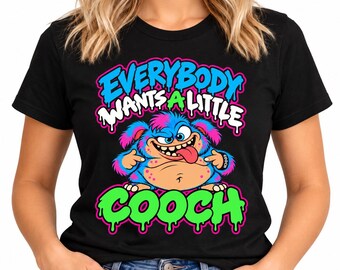 Humorous Graphic T-Shirt: Quirky Blue-Pink Monster & 'Everybody Wants a Little Cooch' Text