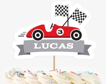 May include: Red race car cake topper with checkered flags, a number 3, and the name Lucas on a gray banner.
