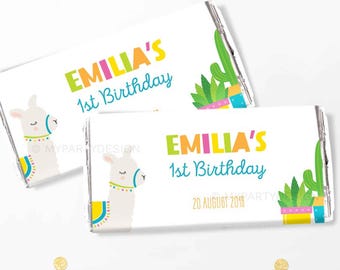 May include: Two white chocolate bar wrappers with a llama and cactus design. The text on the wrappers reads "Emilia's 1st Birthday" and "20 August 2018".