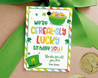 May include: A colorful gift tag with a rainbow striped background and a green shamrock design. The tag says "We're Cereal-sly Lucky to have you!" with a bowl of cereal and a leprechaun hat.