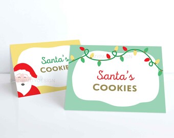 May include: Two Christmas-themed cards with the text "Santa's Cookies." One card is yellow with a Santa Claus illustration. The other is light green with a string of Christmas lights. Both cards have a white, cloud-shaped background.