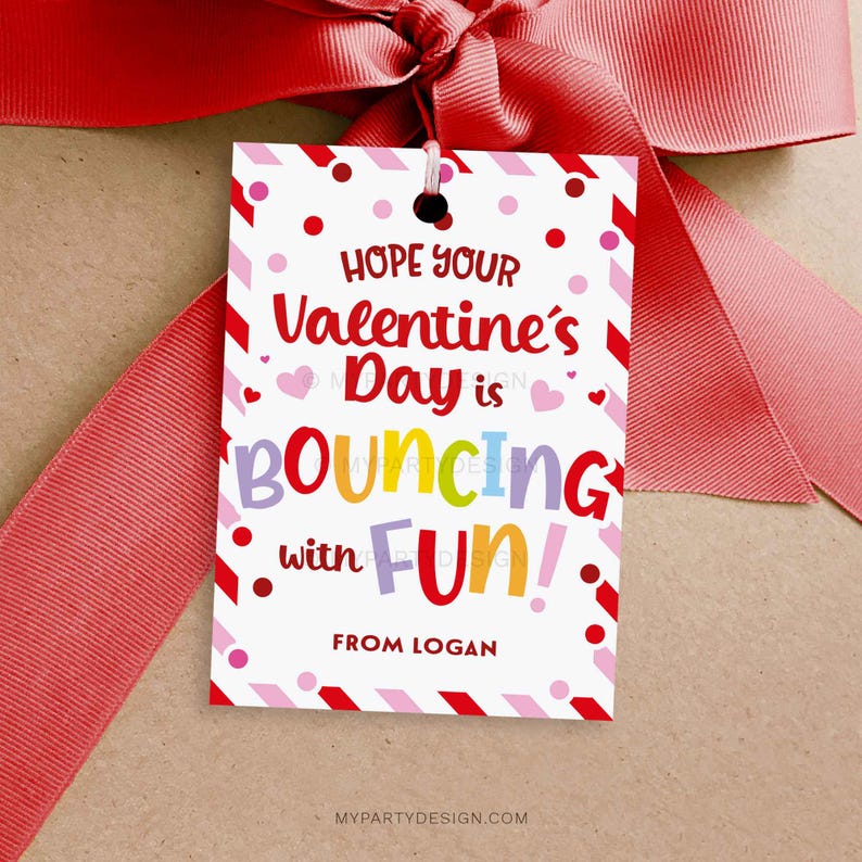 May include: A Valentine's Day gift tag with a red ribbon bow. The white tag has red and pink accents, polka dots, and diagonal stripes. Text reads "Hope Your Valentine's Day is Bouncing with FUN!" and "From Logan."
