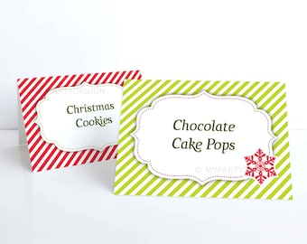 May include: Two Christmas food labels. One has red and white diagonal stripes with the text "Christmas Cookies." The other has green and white stripes with "Chocolate Cake Pops" and a snowflake design.