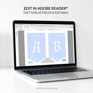 May include: A laptop displays a printable banner design with the text "EDIT IN ADOBE READER&reg; TEXT IN BLUE FIELDS IS EDITABLE". The banner features light blue panels with the letters "A" and "B" and snowflake accents.