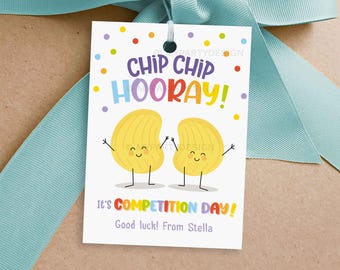 May include: A white tag with a colorful chip design. The tag says "Chip Chip Hooray!" and "It's Competition Day! Good luck! From Stella".