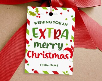 May include: A Christmas gift tag with a red and green design, featuring the text "Wishing you an EXTRA merry Christmas" in festive colors. The tag is tied with a red ribbon, perfect for holiday presents.