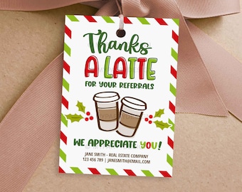 May include: A gift tag with a white background, green and red striped border, and the text "Thanks A LATTE for your referrals." Two coffee cups and holly sprigs are illustrated below the text. The tag also includes contact information.
