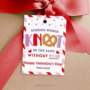 May include: A Valentine's Day gift tag with a red ribbon. The tag has a white background with red and pink accents. Text includes "School Would Knot Be The Same Without You!" and "Happy Valentine's Day!"