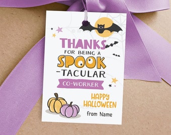 May include: A Halloween-themed gift tag with a purple ribbon. The tag features the words "THANKS FOR BEING A SPOOK-TACULAR CO-WORKER" in orange and purple. A bat, moon, and pumpkins are also on the tag. The words "HAPPY HALLOWEEN" are also on the tag.