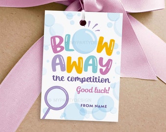 May include: A blue and white gift tag with the text "Blow Away the competition. Good luck!" and a cartoon bubble wand. The tag is decorated with colorful bubbles.
