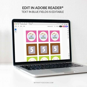 May include: A laptop displays a digital design with editable fields. The design features pink, brown, and green squares with mountain graphics and the text "CAMP NAME" and the number "5". The text "EDIT IN ADOBE READER&reg; TEXT IN BLUE FIELDS IS EDITABLE" is at the top.