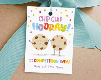 May include: A white gift tag with a colorful 'Chip Chip Hooray!' message and two cartoon cookies holding hands. The text 'It's Competition Day!' is below the cookies, with 'Good luck! From Name' underneath.