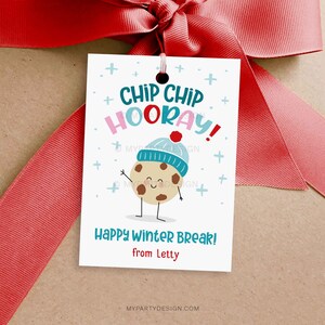 May include: A white gift tag with a red ribbon. The tag features the text "Chip Chip Hooray!" and "Happy Winter Break!" with a cartoon cookie wearing a blue hat. The tag is a festive design for winter.