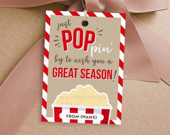 May include: A red and white striped gift tag with the text "just POP pin' by to wish you a GREAT SEASON!" and a cartoon image of a popcorn bucket. The tag also says "FROM (NAME)" at the bottom.