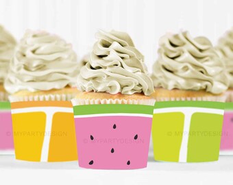 May include: Three cupcakes with white frosting and colorful cupcake liners. The liners are decorated with watermelon, orange, and lime slices.
