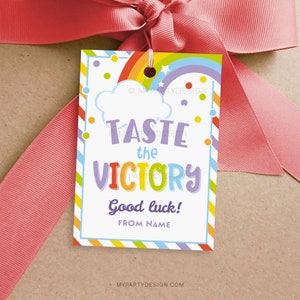 May include: A colorful gift tag with a rainbow, clouds, and the text "Taste the Victory" and "Good luck! From Name".