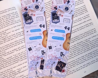 May include: Two decorative bookmarks with a collage design featuring guitars, hockey elements, and the text "The Deal" and "44". The bookmarks are placed on an open book.