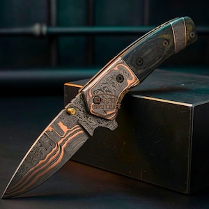 May include: A handcrafted folding knife with a patterned blade and copper accents. The handle is dark wood with copper and black hardware. The blade has a unique pattern with copper-colored accents. The knife is displayed on a dark surface.