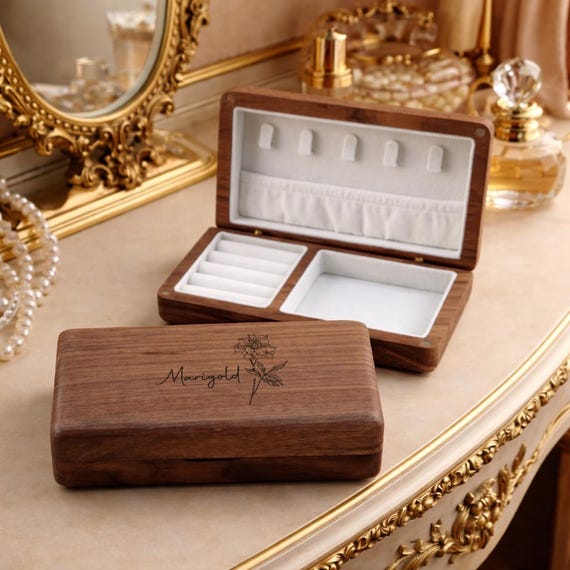 A laser-cut walnut jewelry box personalized with a birth-flower design — the combination of warm wood, botanical engraving, and custom name elevates it well above a plain box.