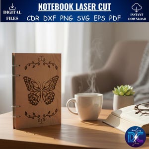 May include: A wooden notebook with a laser-cut butterfly design. The notebook is open, revealing the pages. The image also shows a cup of coffee, a book, and a small plant. Text on top says "NOTEBOOK LASER CUT".