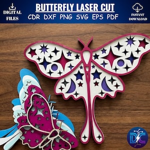 May include: Butterfly laser cut design in layered wood. The design features a large butterfly with star and moon cutouts in shades of white, pink, purple, and blue. The image includes the text "BUTTERFLY LASER CUT" and "DIGITAL FILES".