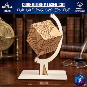 May include: A laser-cut wooden cube globe with detailed map lines, mounted on a wooden stand. The text "CUBE GLOBE V LASER CUT" and file type options are displayed above. The design is suitable for digital files.