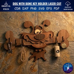 May include: A wooden dog-shaped key holder with a bone-shaped design. The key holder has a smiling dog face and bone-shaped hooks for keys. The text "DOG WITH BONE KEY HOLDER LASER CUT" is at the top. The key holder is made of wood.