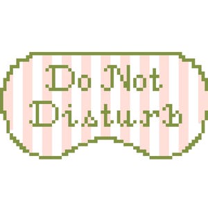 Peut inclure: Masque de sommeil pixelisé avec les mots "Do Not Disturb" en vert. Le masque a un motif à rayures roses et blanches et une bordure verte, parfait pour une nuit de sommeil relaxante.
