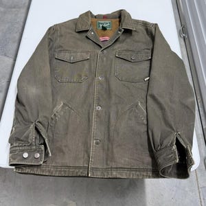 May include: A set of three ceramic mugs with a speckled, matte finish. The mugs are in shades of cream, light gray, and dark gray. Each mug has a simple, minimalist design and a rounded handle.