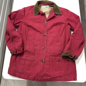 May include: A red jacket with a brown corduroy collar and cuffs. The jacket has four buttons down the front, two front pockets, and a plaid lining visible at the collar. The L.L.Bean logo is visible on the collar.