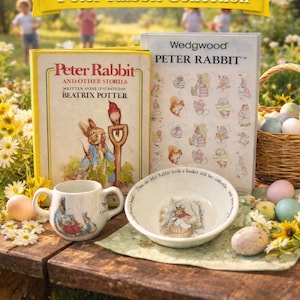 May include: A collection of Peter Rabbit themed items, including books, a mug, and a bowl. The books are titled "Peter Rabbit and Other Stories" and "Wedgwood PETER RABBIT". The mug and bowl feature illustrations of Peter Rabbit. The scene is set outdoors with flowers and Easter eggs.