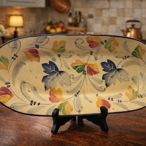 May include: A set of three ceramic nesting bowls in shades of blue, green, and white. The bowls feature a speckled glaze and a simple, modern design. The largest bowl is approximately 6 inches in diameter.